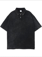 Oversized black washed polo shirt with short sleeves and a two-button placket.