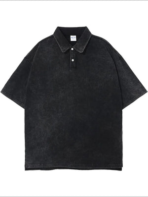 Oversized black washed polo shirt with short sleeves and a two-button placket.
