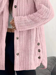 Pink button-up fleece jacket with textured fabric and dark buttons.