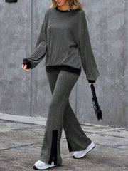 Gray ribbed knit lounge set with crew neck sweater and slit hem pants.