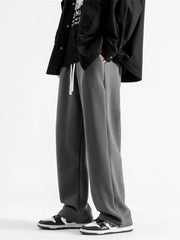 Dark gray casual loose fit sweatpants with white drawstring and pockets.
