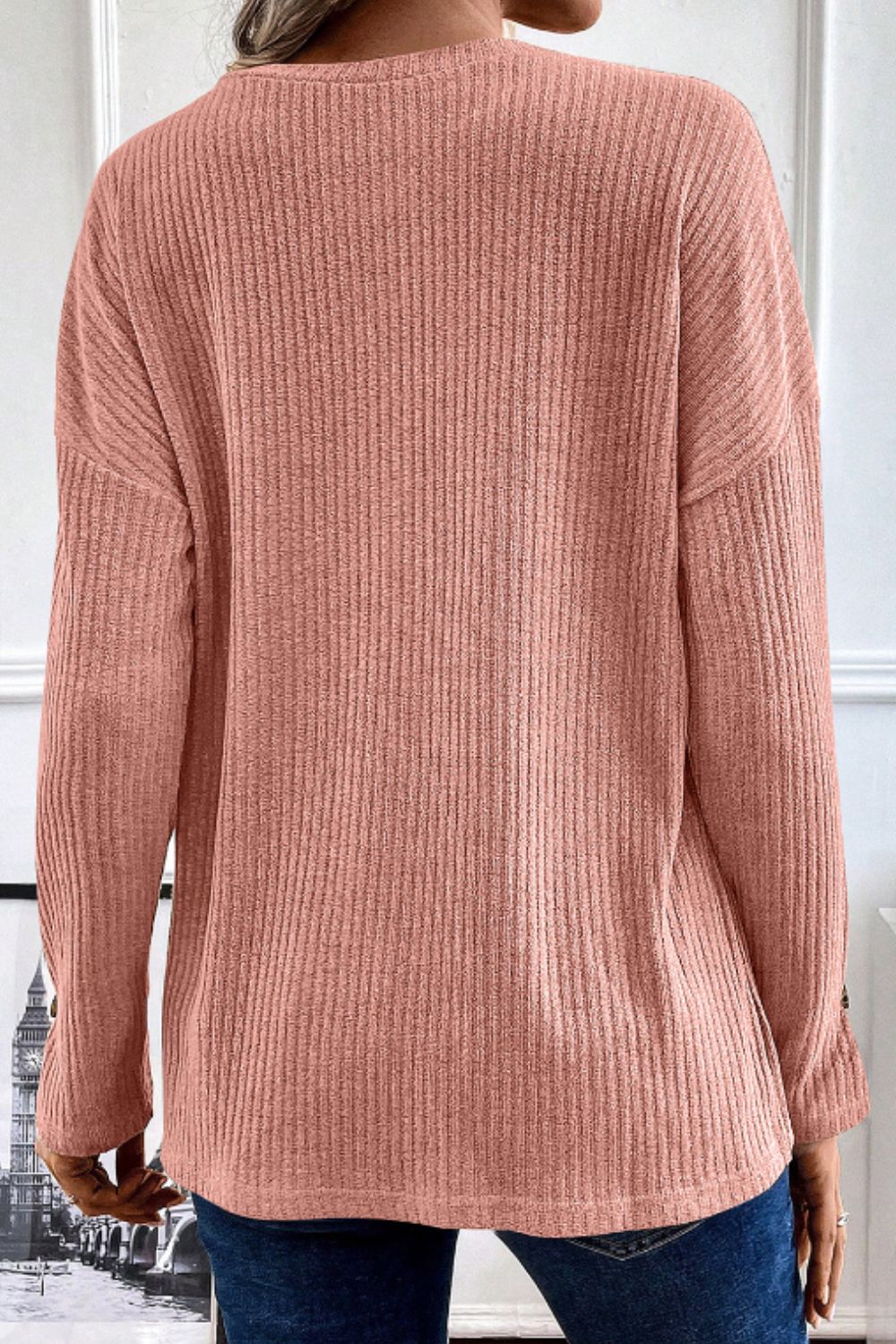 Dusty Pink ribbed knit henley top with button detail on sleeve.