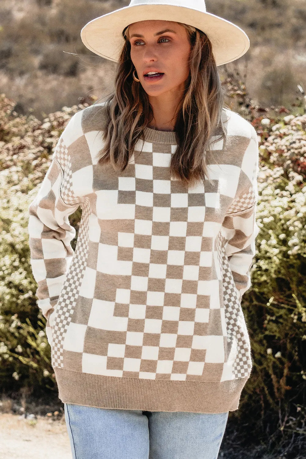 Geometric knit checkerboard pullover sweater in mocha and white with crew neck and long sleeves.