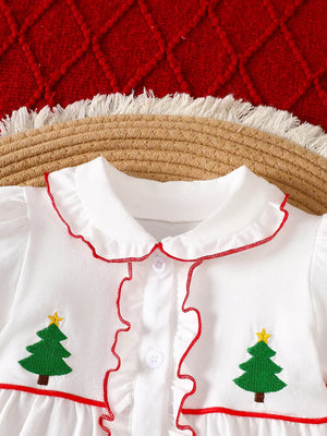White baby dress with embroidered Christmas trees, red trim, and ruffles.