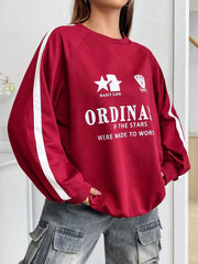 Deep red raglan sleeve sweatshirt with white stripe details and graphic print.