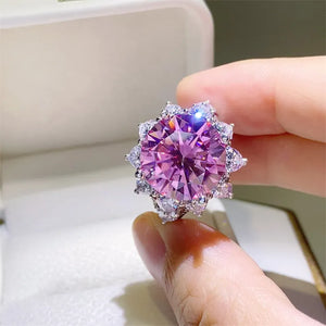 Radiant Blossom cocktail ring in silver with a large pink center stone and halo of white stones.