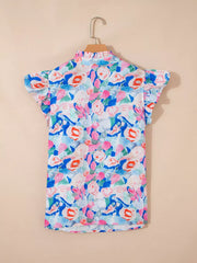 Vibrant floral cotton blouse with tie neck and ruffle sleeves.