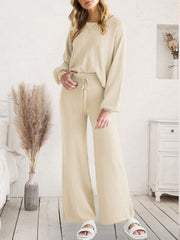 Wide-leg knit loungewear set in ivory with drawstring waist and crew neck top.