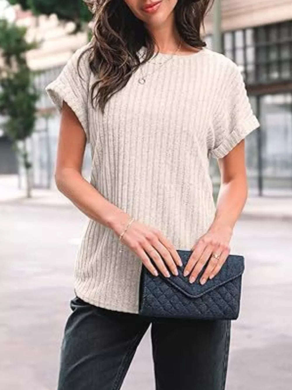 Ribbed knit t-shirt in light beige with cuffed short sleeves and a round neckline.