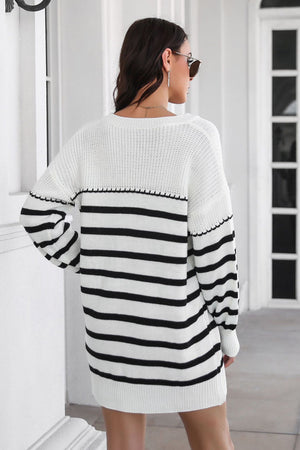 Horizontal stripe knit mini dress in black and white acrylic with a crew neck and long sleeves.