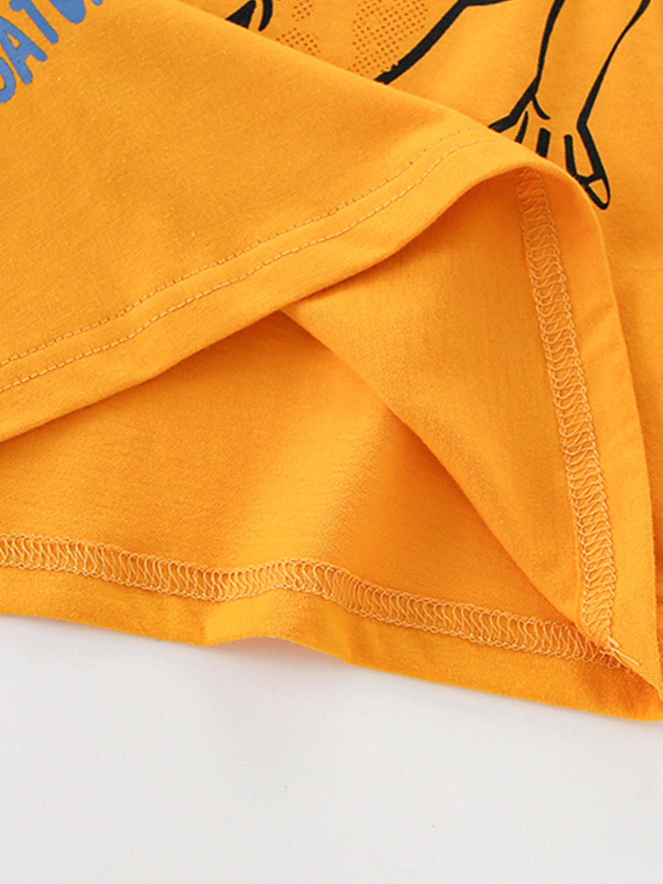 Orange toddler t-shirt with alligator graphic and blue text, showing hem detail.