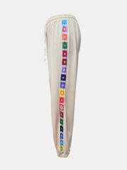 Tan jogger pants with colorful embroidered stripe detail down the side.