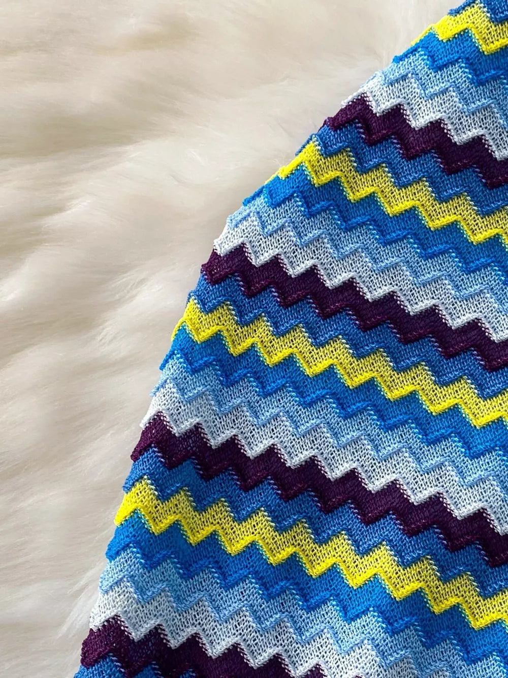 Chevron knit halter crop top in blue, yellow, and purple stripes.