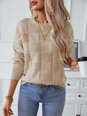 Cream textured checkerboard knit pullover sweater with crewneck and long sleeves.