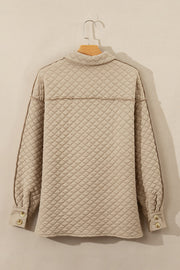 Diamond quilted beige oversized button-up jacket with raw edge detail and button cuffs.