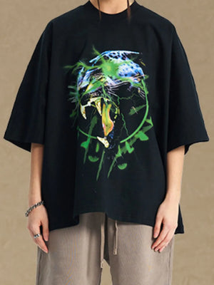 Black oversized tee with a bold graphic print of a roaring leopard with green lightning accents.