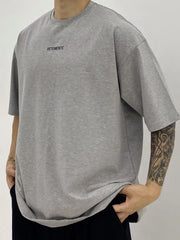 Gray oversized t-shirt with small black VETEMENTS logo on chest.