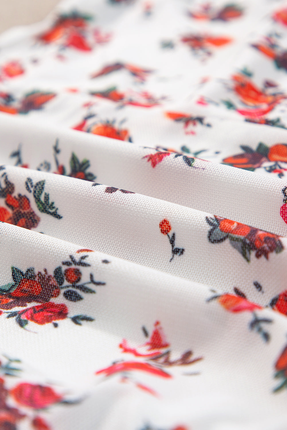 White floral bustier camisole with red and green blooms