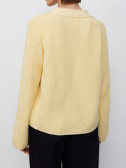 Yellow ribbed raglan cardigan with deep V-neck and button details.