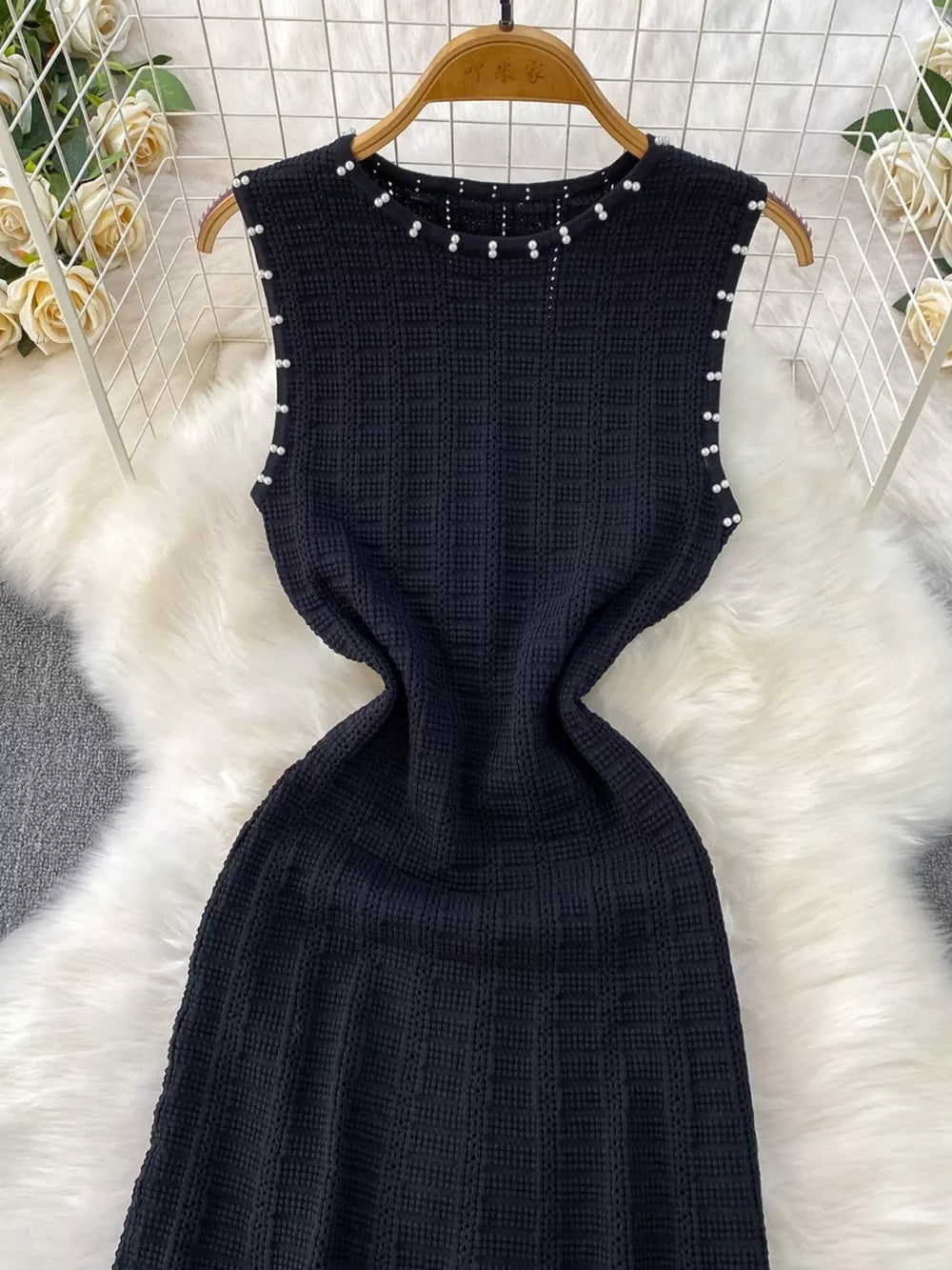 Black textured knit midi dress with pearl neckline and armhole details.