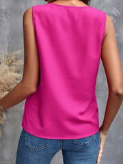 Hot Pink sleeveless blouse with a round neckline, styled with blue jeans.