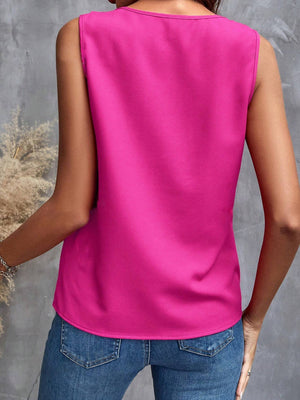 Hot Pink sleeveless blouse with a round neckline, styled with blue jeans.