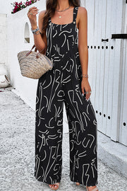 Black abstract scribble wide leg jumpsuit with button straps and square neckline.