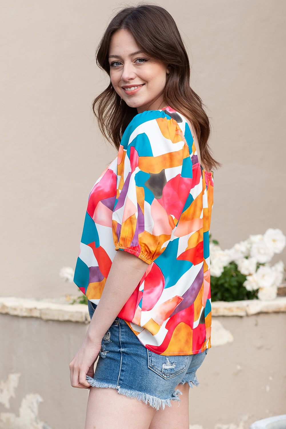 Abstract print puff sleeve blouse with multicolor artful pattern and square neckline.