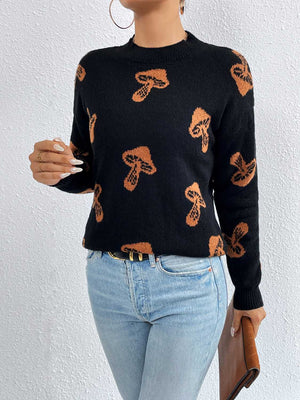 Black knit sweater with allover orange mushroom print, drop shoulder, and crew neck.