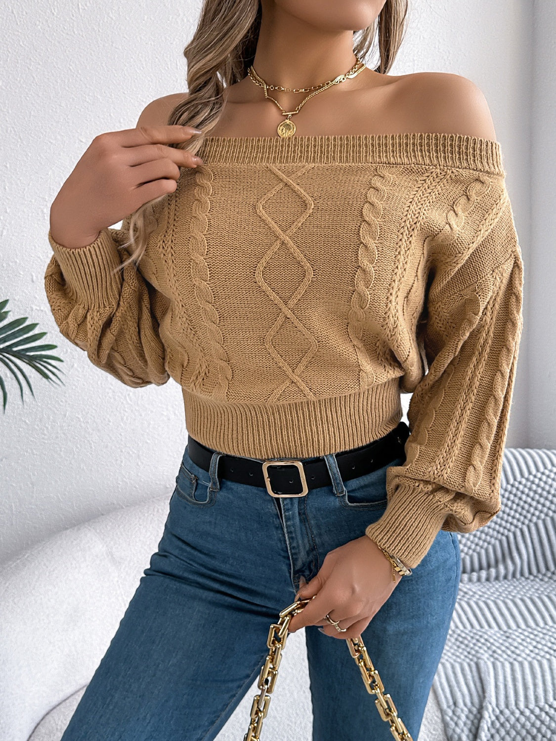 Camel cable knit off-shoulder crop sweater with diamond pattern and balloon sleeves.