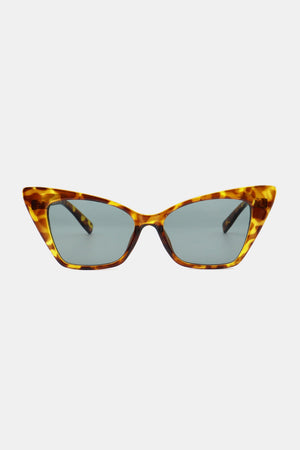 Sharp angular cat-eye sunglasses in tortoise shell acetate with grey lenses.