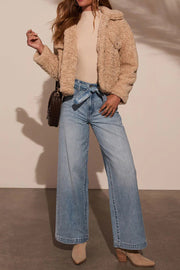 Belted wide-leg denim trousers in medium wash, tied at the waist.