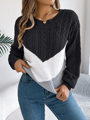 Black chevron cable knit sweater with white and grey colorblock detail.