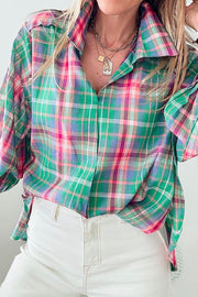 Voluminous plaid blouse with gathered sleeves in green, pink, and purple plaid.