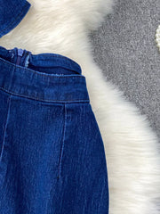 Dark blue cotton denim vest and flare jeans set with asymmetrical button detail and zipper closure.