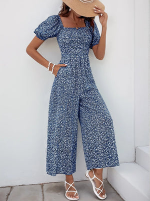 Smocked bodice floral wide-leg jumpsuit in Royal Blue with puff sleeves and square neckline.