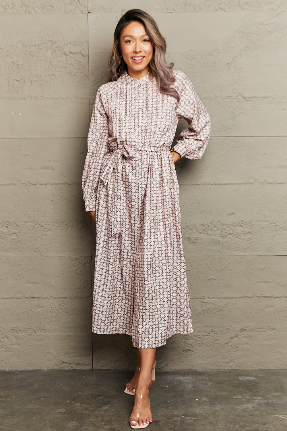 Beige geometric print midi dress with belt, long sleeves, and A-line cut.