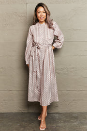 Beige geometric print midi dress with belt, long sleeves, and A-line cut.