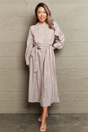 Beige geometric print midi dress with belt, long sleeves, and A-line cut.