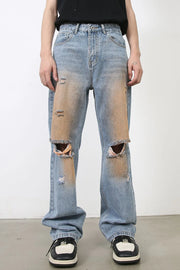 Light blue wide leg denim jeans with faded wash, distressed details, and ripped knees.