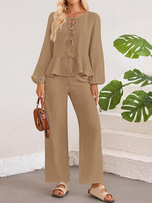 Camel textured peplum tie-neck co-ord set with balloon sleeves and wide-leg pants.