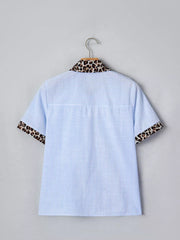 Blue striped button-down shirt with leopard print collar and cuffs