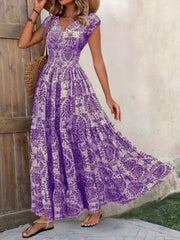 Purple damask print cap sleeve maxi dress with smocked waist and tiered skirt.