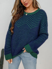 Chevron knit crewneck sweater in dark blue and green with a fuzzy texture.