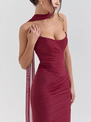 Burgundy sweetheart tube top dress with ruched detailing and sheer scarf accent.
