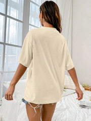 Oversized tan graphic tee with short sleeves and a relaxed fit.