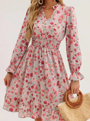 Romantic floral smocked dress in blush pink with ruffled cuffs and hem.