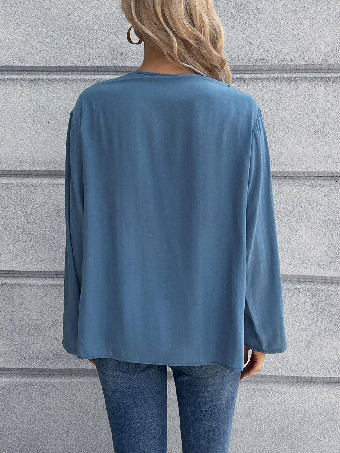 Dusty Blue long sleeve blouse with a relaxed fit, shown from the back.
