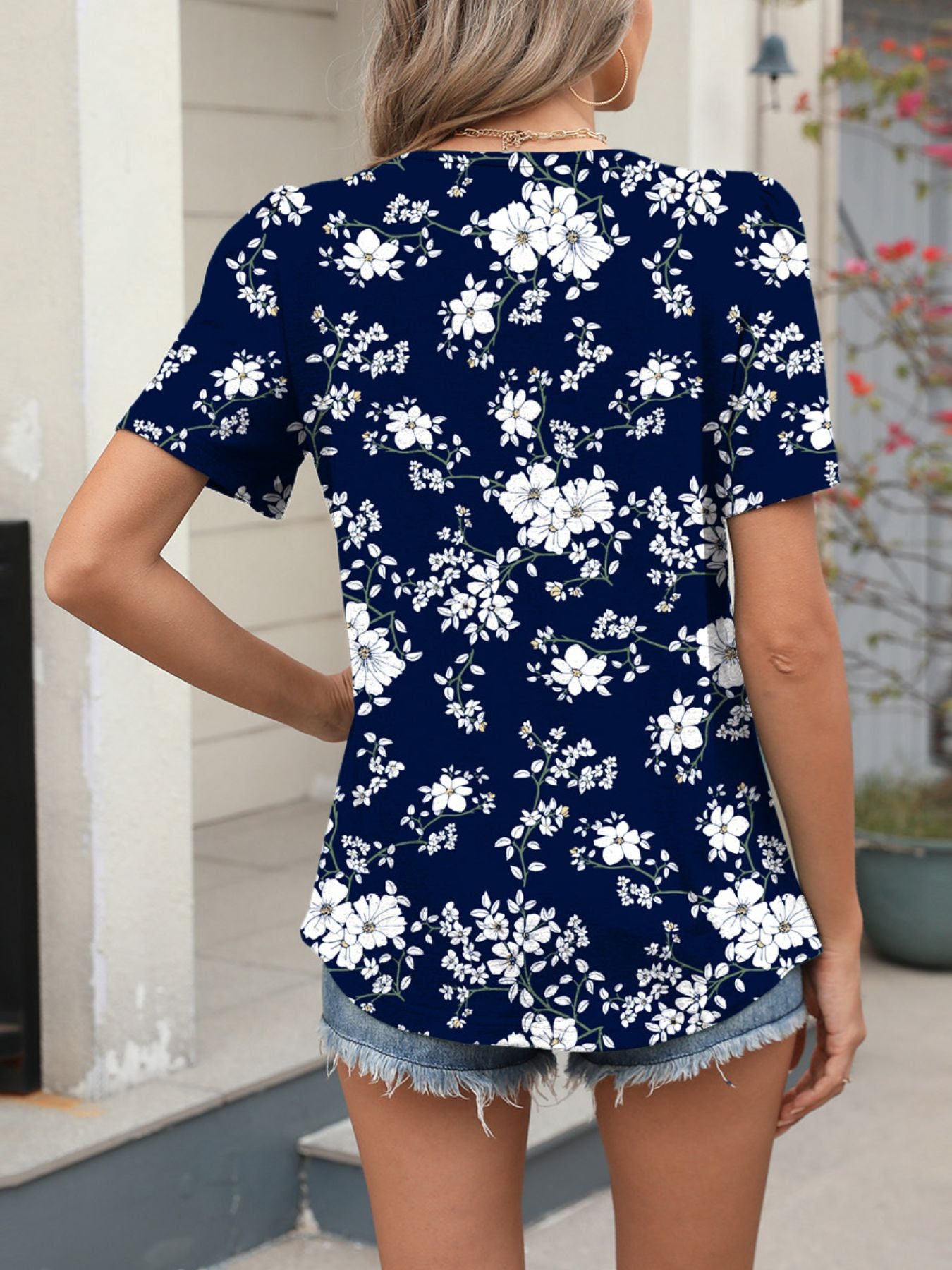 Women's dark blue floral print short sleeve blouse with a v-neck.