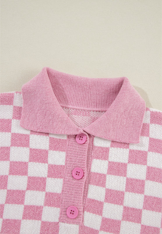 Pink checkerboard knit polo sweater with button front and collar.
